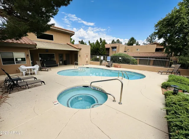 a view of a house with swimming pool and sitting area