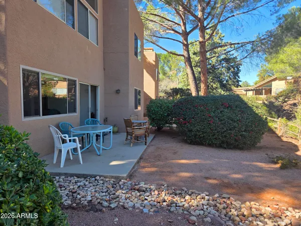 a view of a patio with table and chairs and potted plants