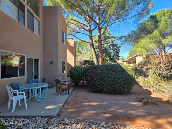 a view of backyard with outdoor seating and plants