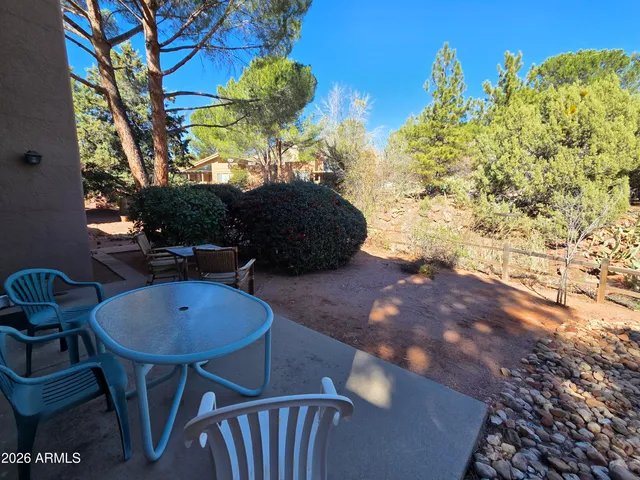 a view of balcony with table and chairs