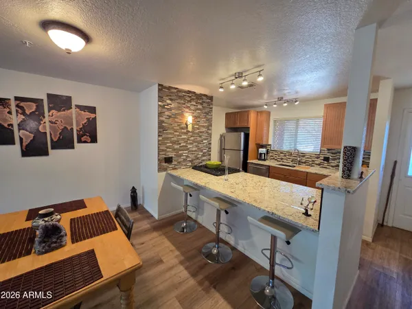 a kitchen with kitchen island a stove and a refrigerator