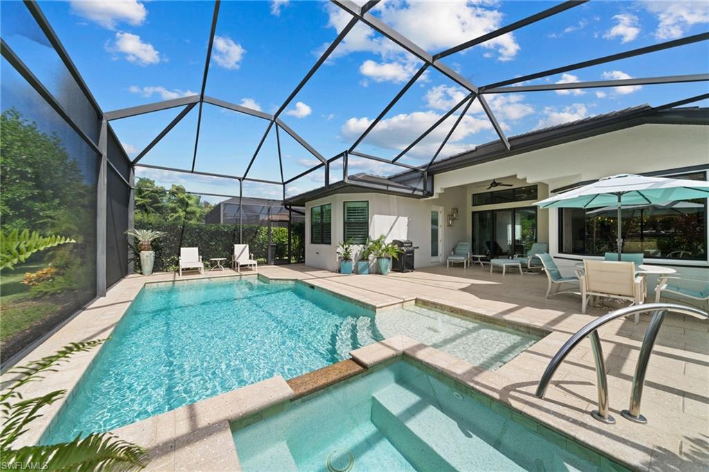 10067 Palazzo Drive Naples, FL 34119 - Photo 1 of 46 a view of a swimming pool with a patio