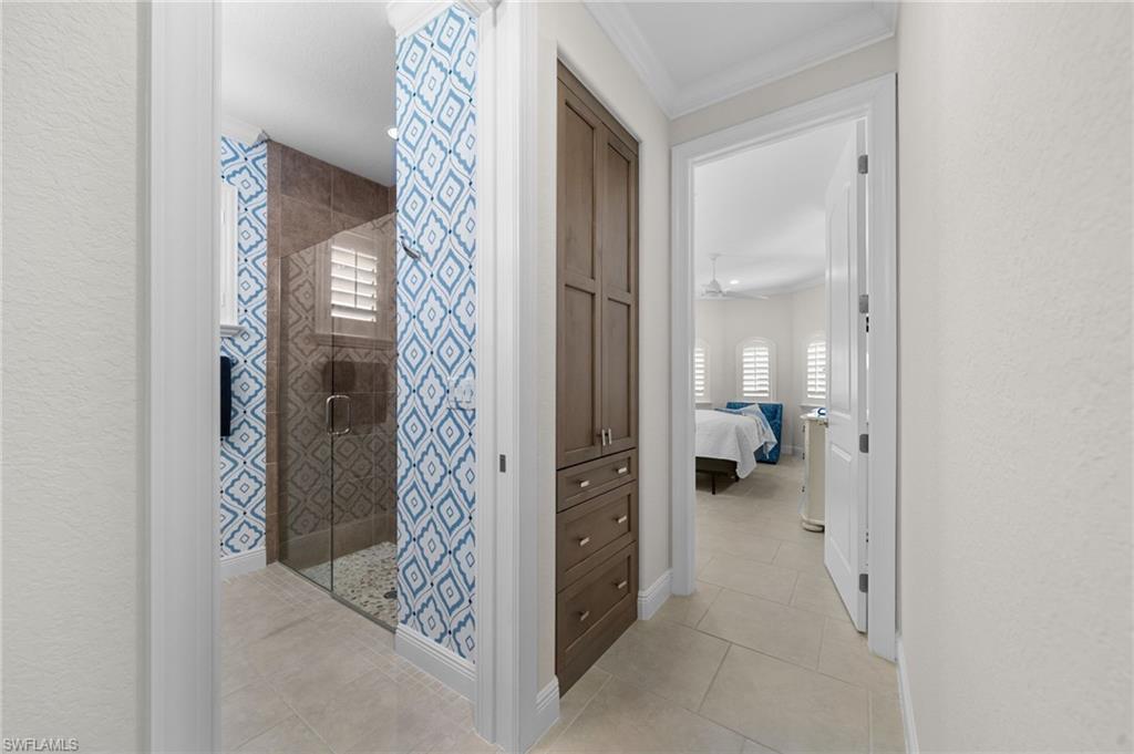 10067 Palazzo Drive Naples, FL 34119 - Photo 24 of 46 a hallway with kids room bathroom