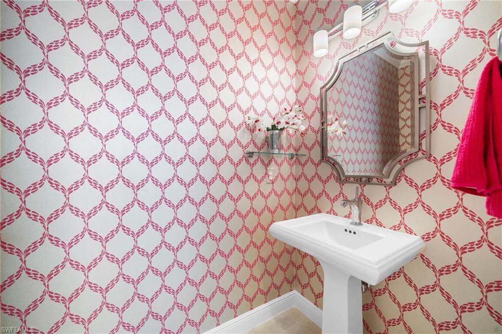 10067 Palazzo Drive Naples, FL 34119 - Photo 30 of 46 a bathroom with a sink and a mirror