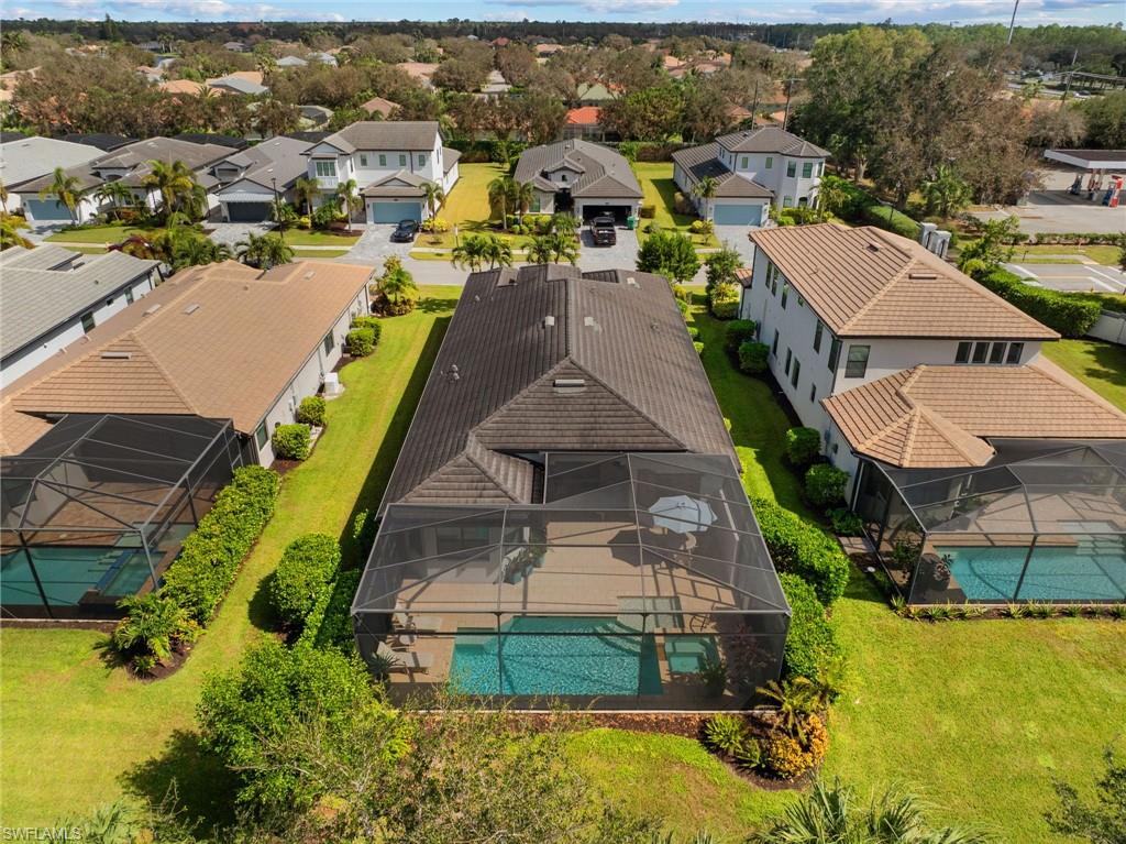 10067 Palazzo Drive Naples, FL 34119 - Photo 42 of 46 an aerial view of a house with a swimming pool yard and outdoor seating