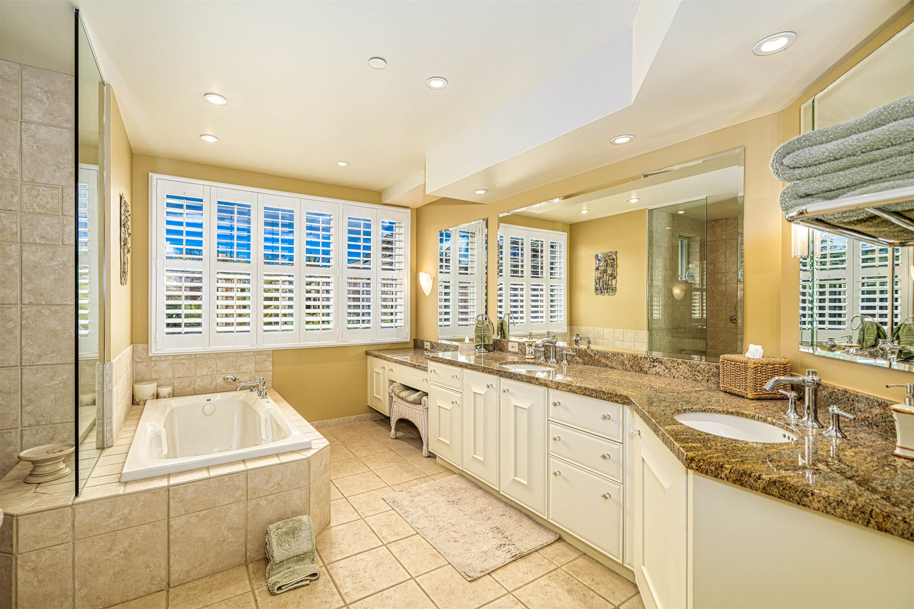 4955 Makena Road, Unit E301 Kihei, HI 96753 - Photo 15 of 22 a large bathroom with a granite countertop tub and a sink