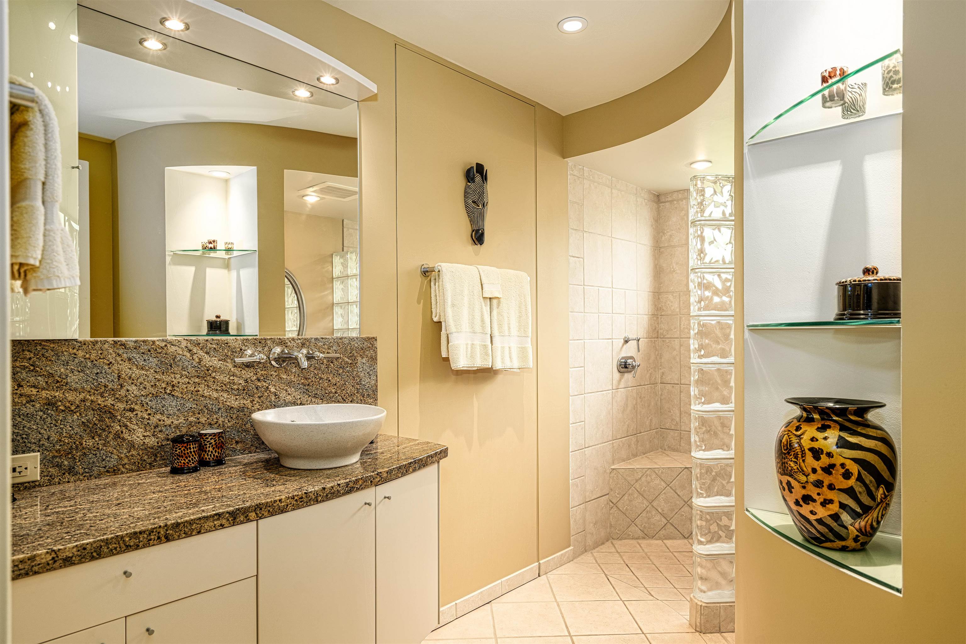 4955 Makena Road, Unit E301 Kihei, HI 96753 - Photo 16 of 22 a bathroom with a granite countertop sink a toilet and shower