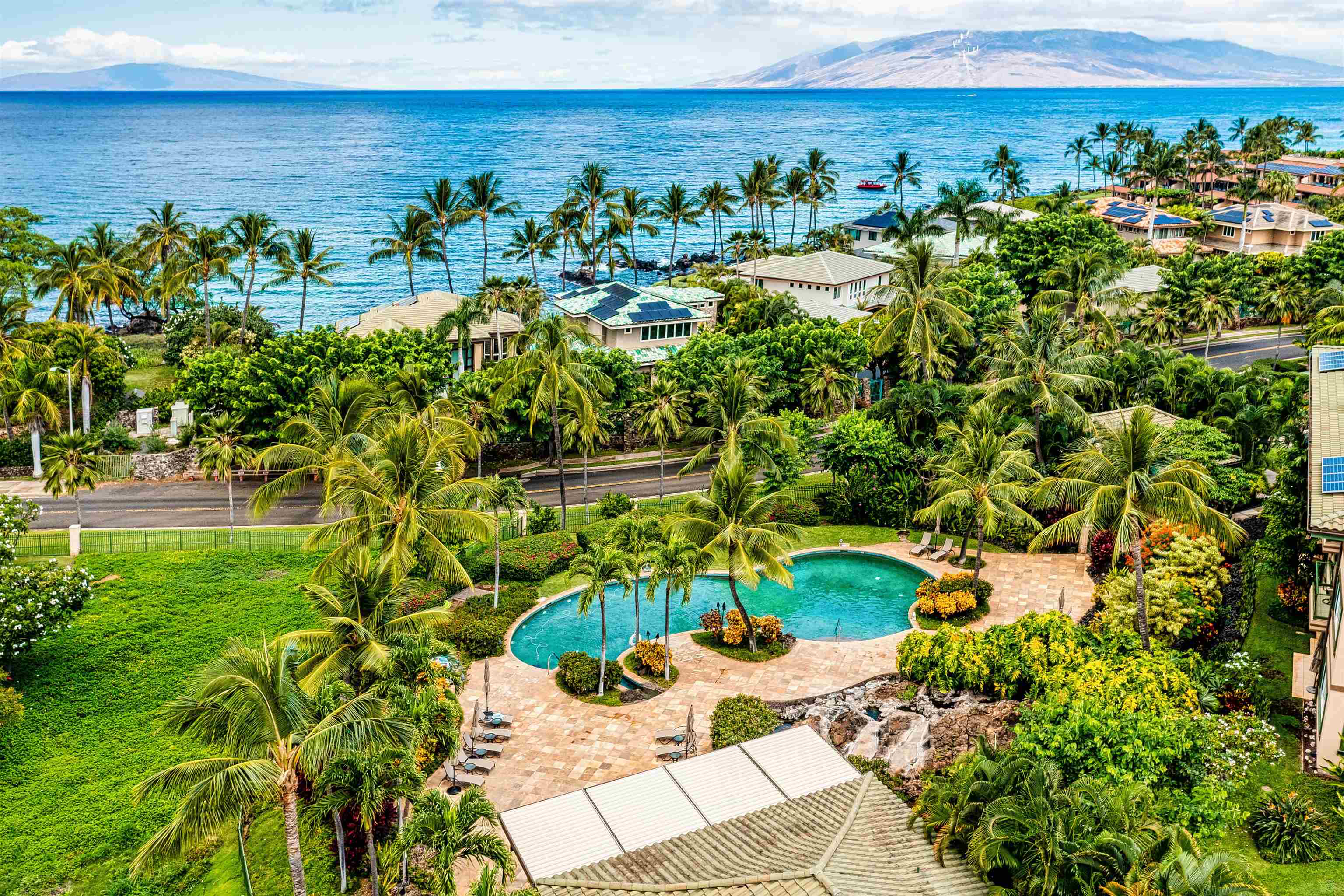 4955 Makena Road, Unit E301 Kihei, HI 96753 - Photo 3 of 22 a view of a yard with plants and large trees