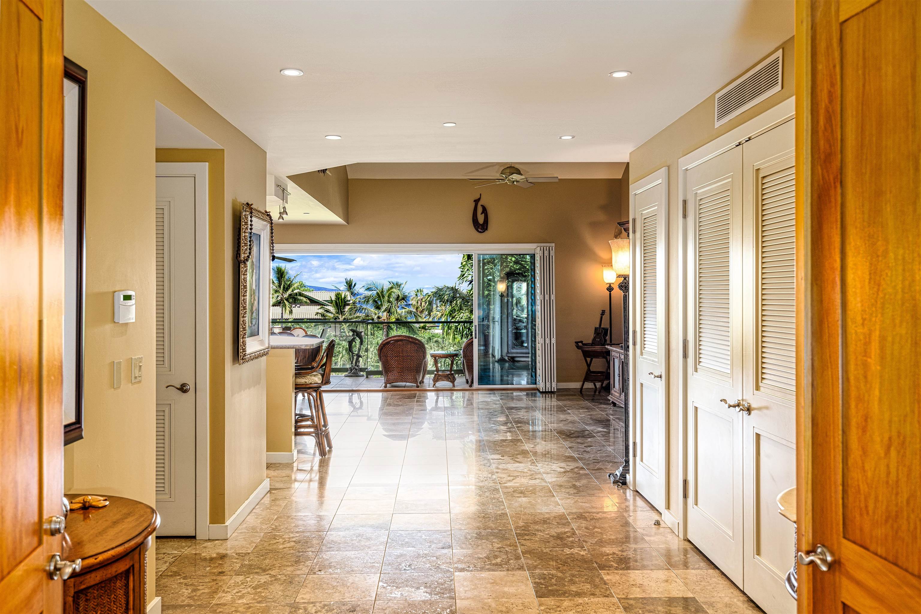 4955 Makena Road, Unit E301 Kihei, HI 96753 - Photo 10 of 22 a view of a living room with a floor to ceiling window and wooden floor
