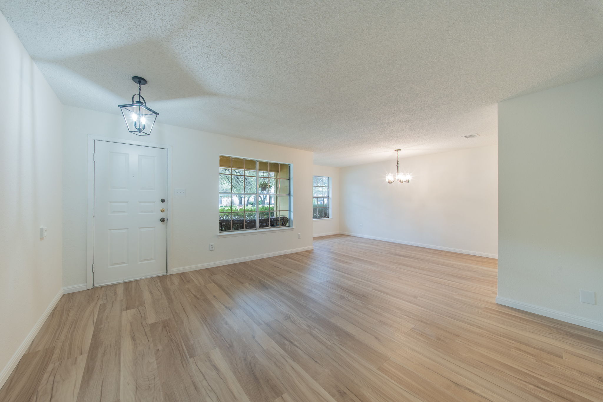 4504 Langtry Lane Austin, TX 78749 - Photo 9 of 24 Natural light dances across wide plank flooring in this welcoming open-concept living space.