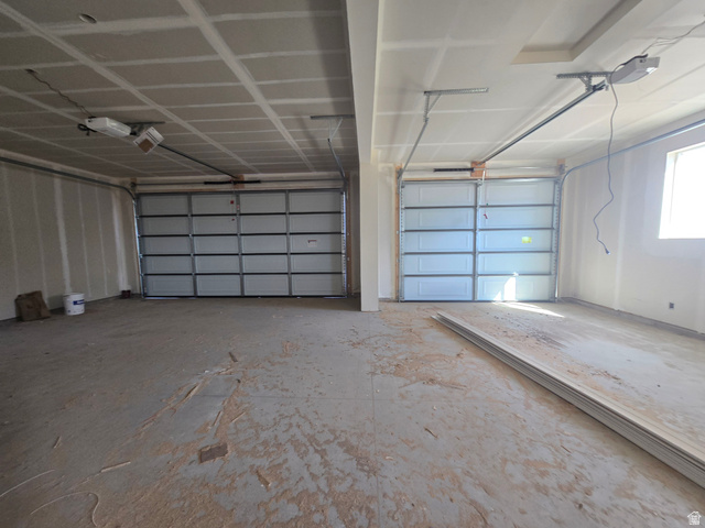 1651 West Ross Road Syracuse, UT 84075 - Photo 13 of 15 Garage featuring a garage door opener