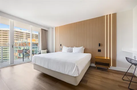 a bedroom with a large bed and a large window