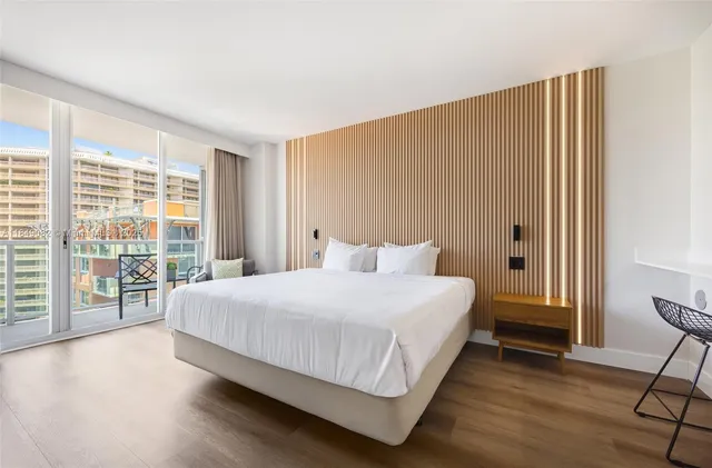 a bedroom with a large bed and a large window