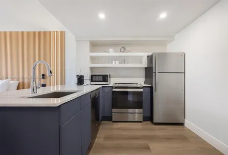 a kitchen with a sink appliances and cabinets
