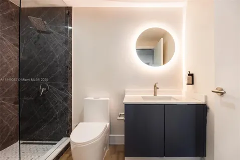 a bathroom with a sink toilet and a mirror