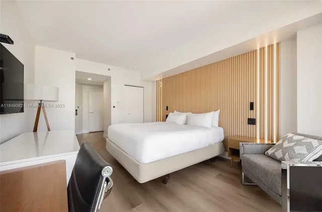 a bedroom with a bed and a couch