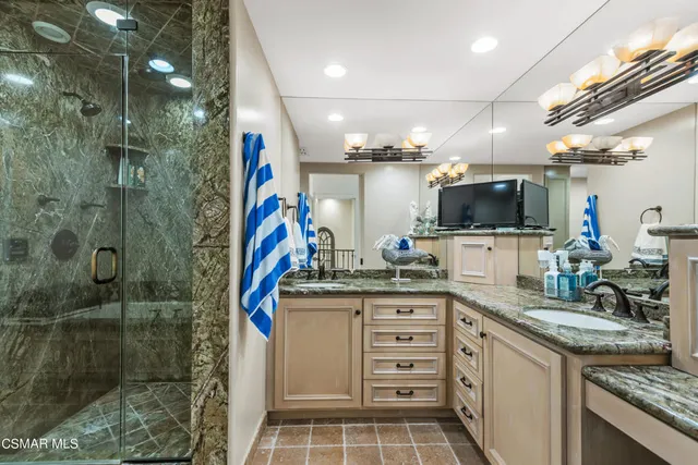 a kitchen with granite countertop a sink and a stove top oven