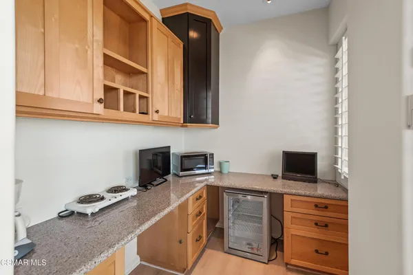 a kitchen with a microwave and cabinets