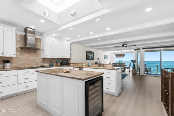 a kitchen with appliances a sink and cabinets