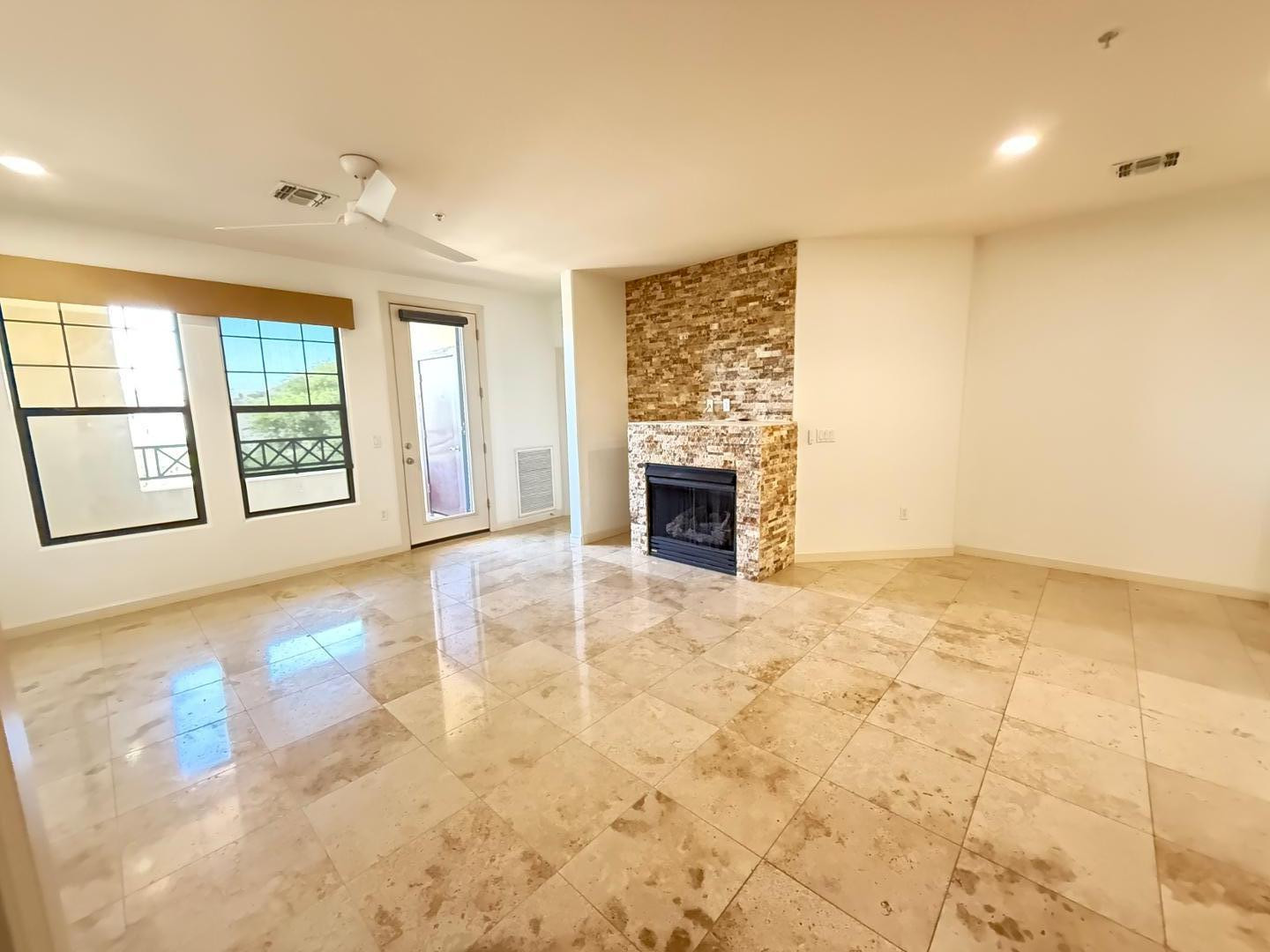 7291 North Scottsdale Road, Unit 3003 Paradise Valley, AZ 85253 - Photo 11 of 45 a view of an empty room with a fireplace and a window