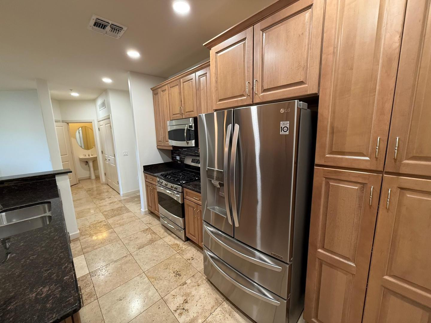 7291 North Scottsdale Road, Unit 3003 Paradise Valley, AZ 85253 - Photo 30 of 45 a kitchen with granite countertop stainless steel appliances a refrigerator and cabinets