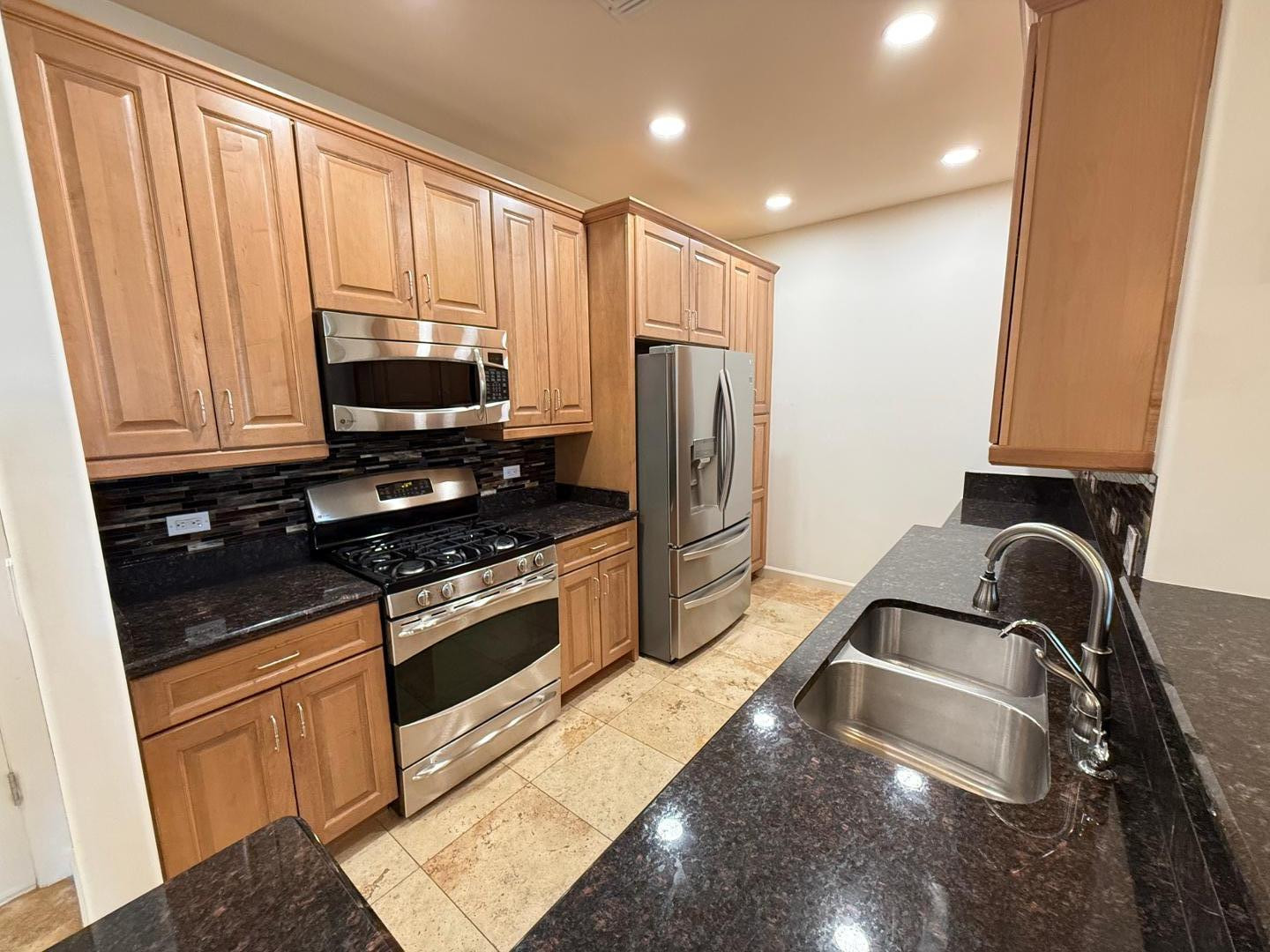 7291 North Scottsdale Road, Unit 3003 Paradise Valley, AZ 85253 - Photo 31 of 45 a kitchen with stainless steel appliances granite countertop a sink stove and refrigerator