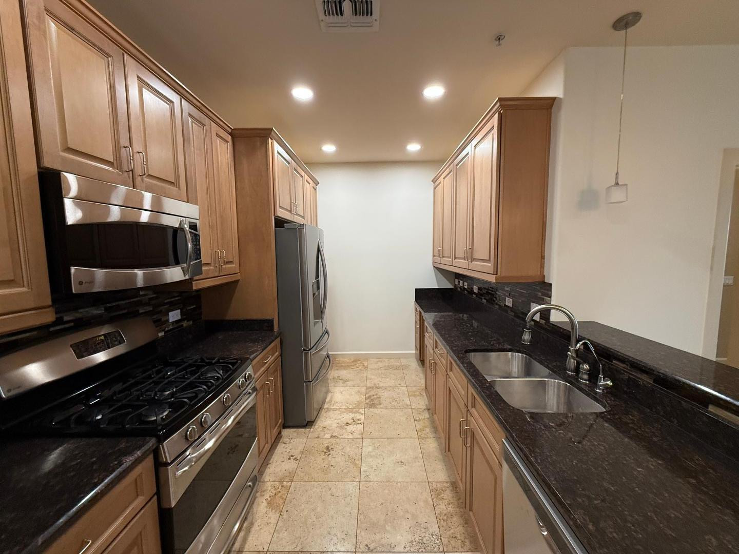 7291 North Scottsdale Road, Unit 3003 Paradise Valley, AZ 85253 - Photo 32 of 45 a kitchen with granite countertop a sink and stainless steel appliances