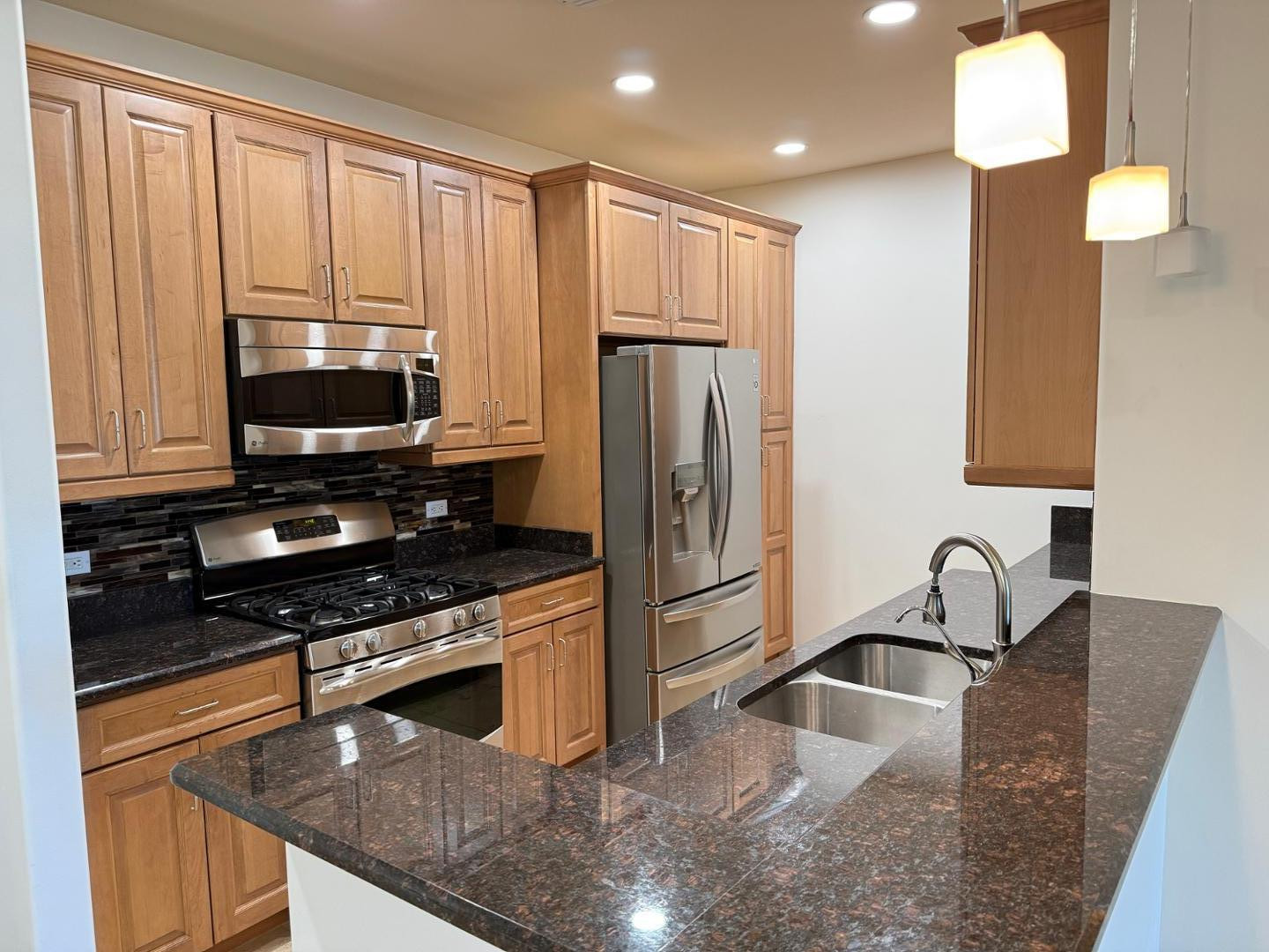 7291 North Scottsdale Road, Unit 3003 Paradise Valley, AZ 85253 - Photo 42 of 45 a kitchen with stainless steel appliances granite countertop a sink a stove and a refrigerator