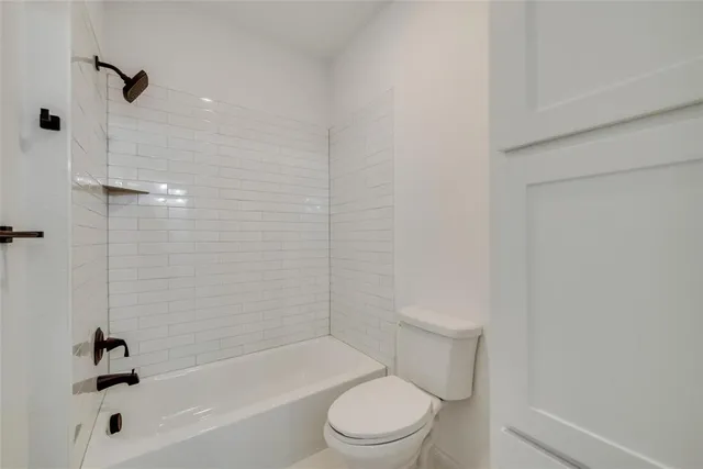 a bathroom with a toilet and a tub