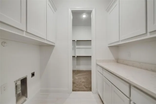 a kitchen with white cabinets and a sink