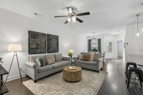 a living room with furniture and a lamp