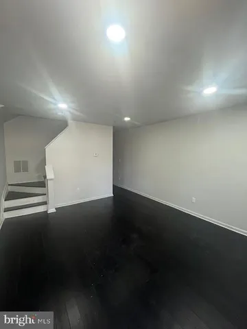 an empty room with wooden floor