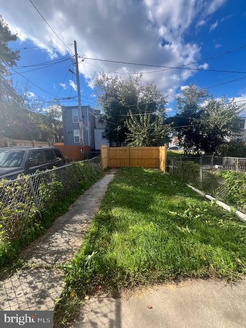 2214 Sidney Avenue Baltimore, MD 21230 - Photo 3 of 10 Lush green yard with a welcoming fence.