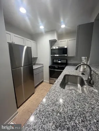 a kitchen with a sink and a refrigerator