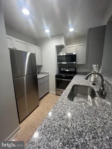 a kitchen with a sink and a refrigerator