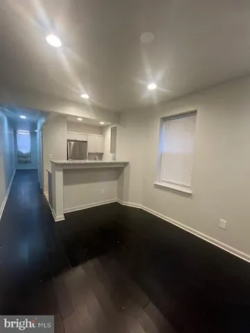 a view of kitchen and hall with wooden floor