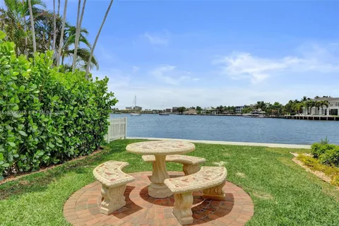 an aerial view of a house with a garden and lake view