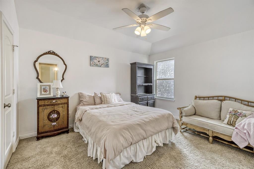 1425 Wildrye Ridge Celina, TX 75009 - Photo 23 of 32 a bedroom with a bed and a chandelier