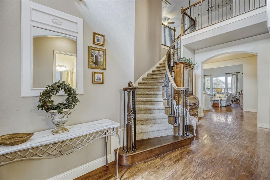 1425 Wildrye Ridge Celina, TX 75009 - Photo 4 of 32 a view of a hallway to a livingroom with wooden floor and stairs