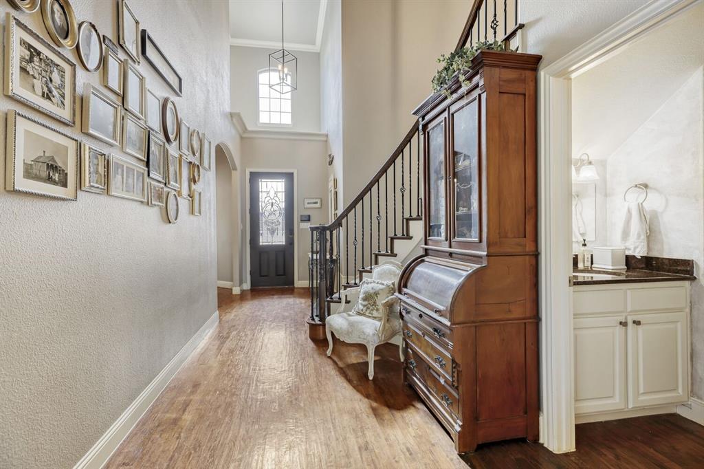 1425 Wildrye Ridge Celina, TX 75009 - Photo 5 of 32 a view of a hallway with entryway and wooden floor
