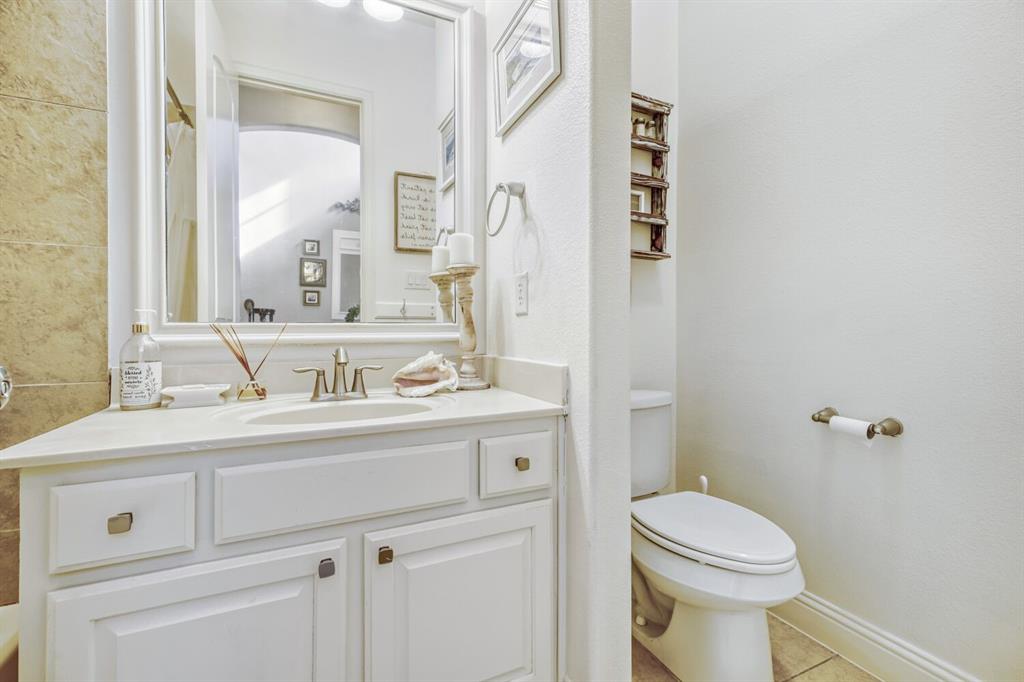 1425 Wildrye Ridge Celina, TX 75009 - Photo 7 of 32 a bathroom with a sink a toilet and a mirror