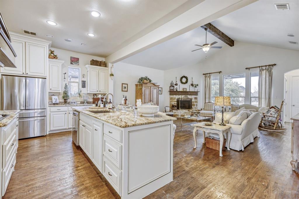 1425 Wildrye Ridge Celina, TX 75009 - Photo 10 of 32 a kitchen with stainless steel appliances granite countertop a stove and a refrigerator