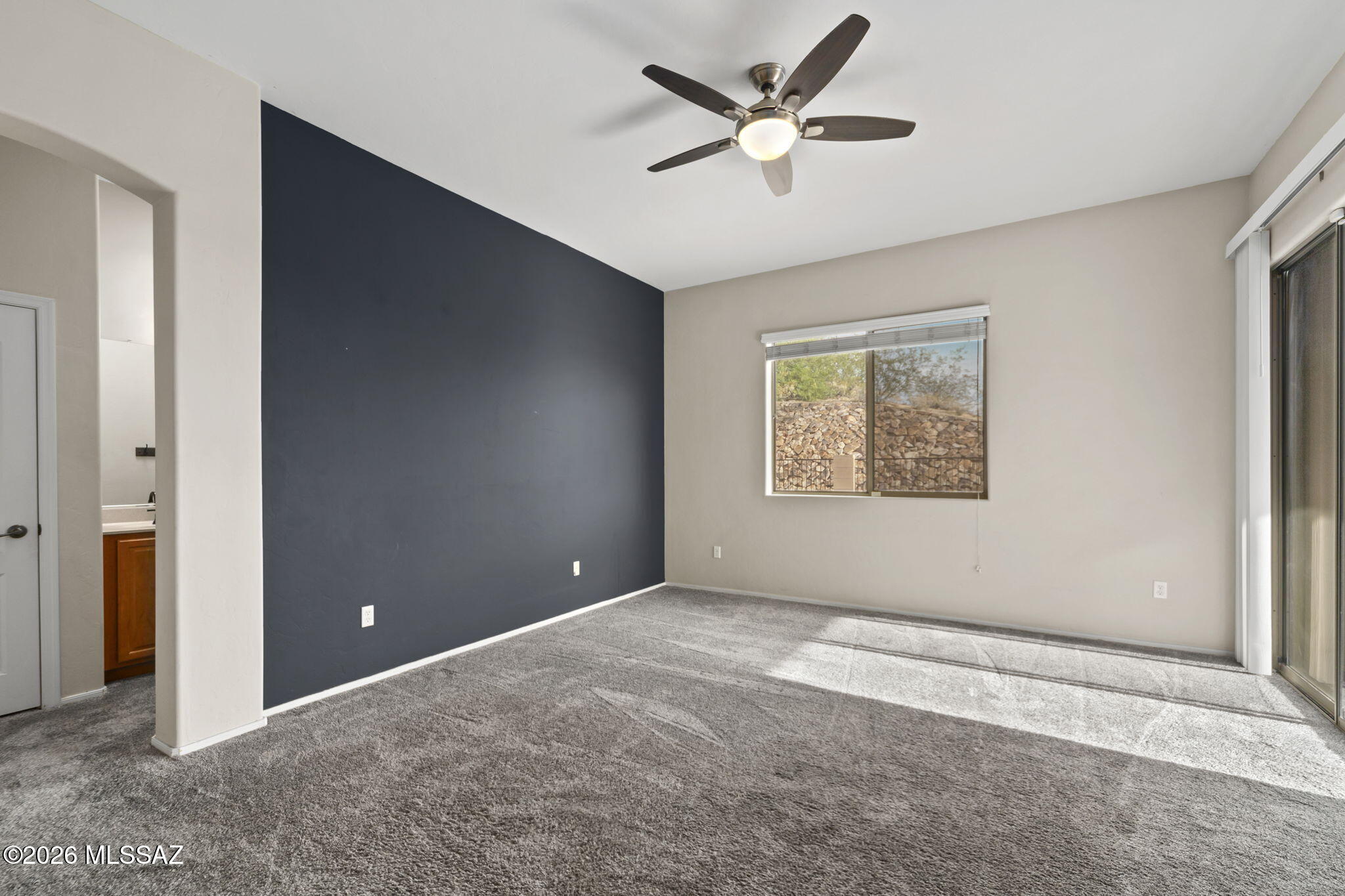 13668 East High Plains Ranch Street Vail, AZ 85641 - Photo 26 of 51 an empty room with windows and a ceiling fan