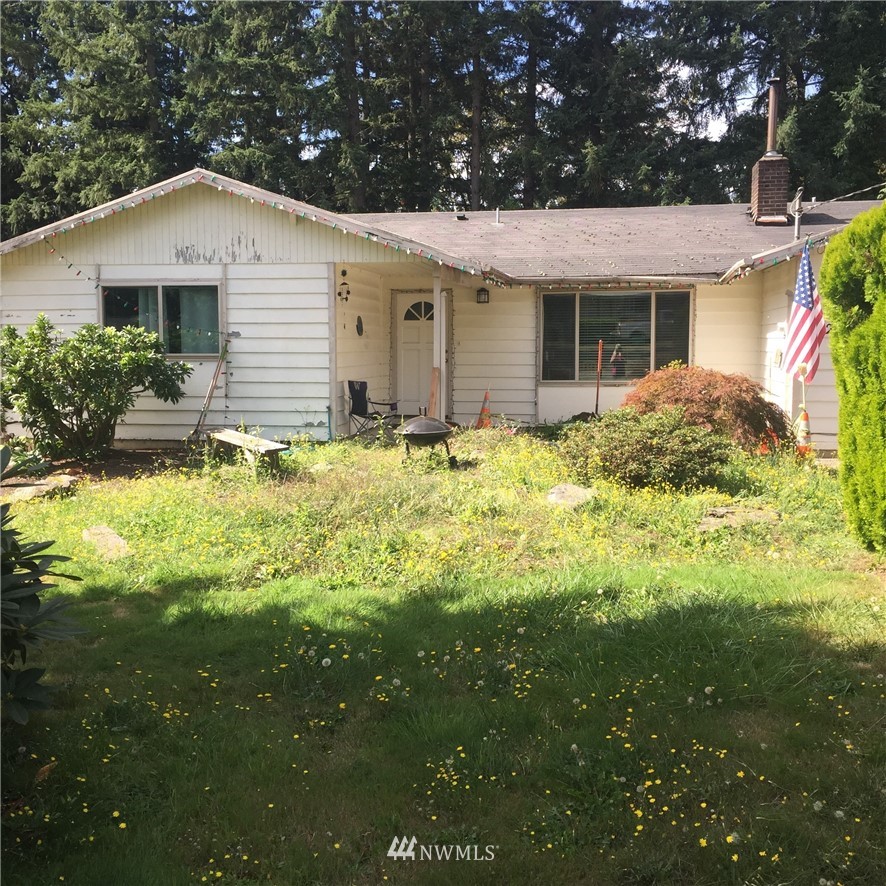 14225 169th Avenue Southeast Renton, WA 98059 - Photo 1 of 8 a front view of a house with a garden and yard