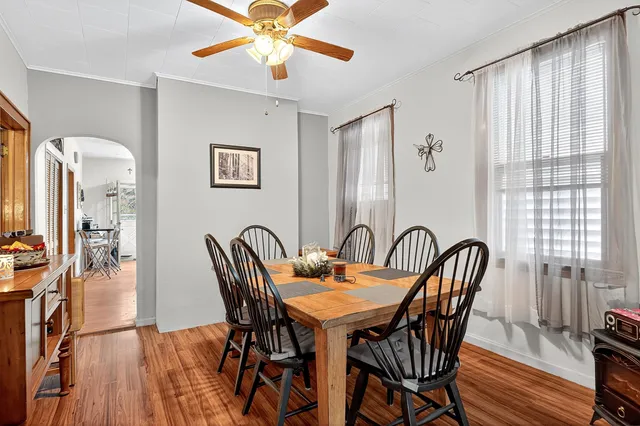 a view of a a dining room with furniture window and wooden floor