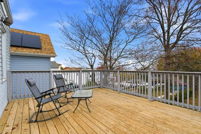 a view of balcony with wooden floor and outdoor seating