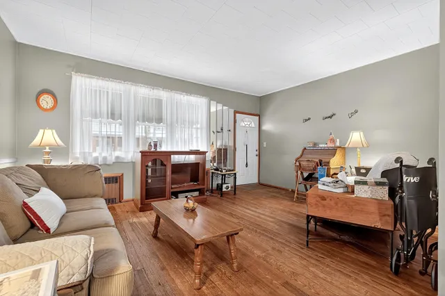 a living room with furniture a table and a large window