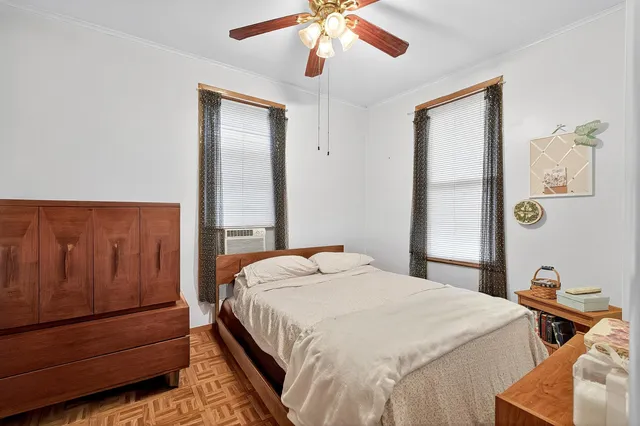 a bedroom with a bed and a chandelier