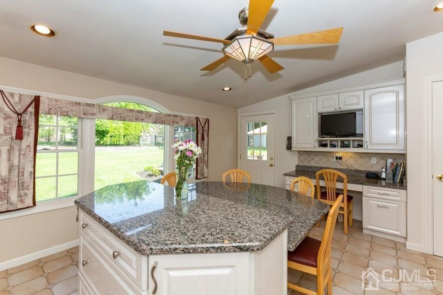 33 Southfield Road Edison, NJ 08820 - Photo 11 of 36 a kitchen with stainless steel appliances granite countertop a sink a counter top space and living room view