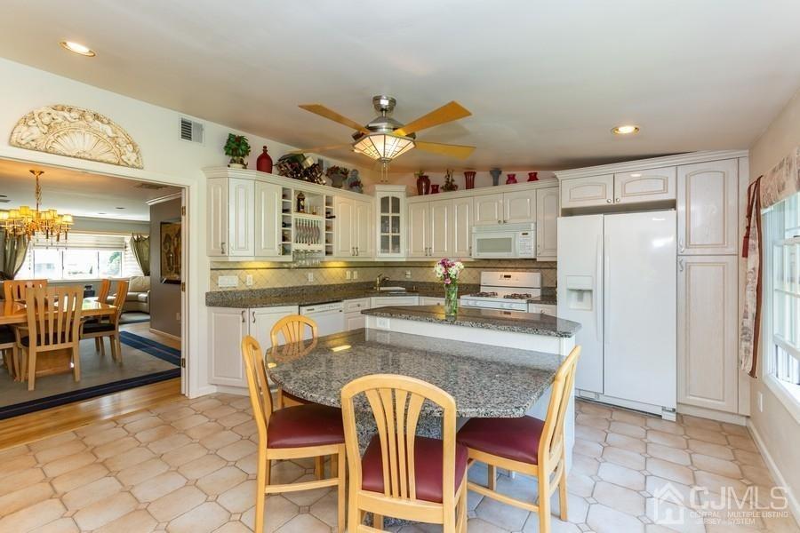 33 Southfield Road Edison, NJ 08820 - Photo 12 of 36 a kitchen with stainless steel appliances granite countertop a sink and a refrigerator